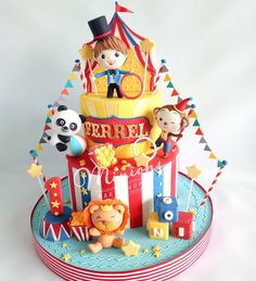 a circus cake with animals and clowns on it's tiered display stand