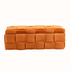 an orange leather box with squares on it