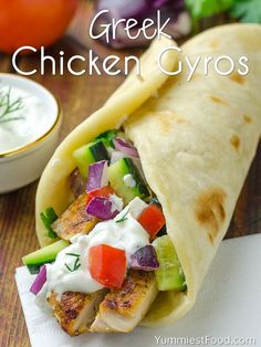 the chicken gyros are loaded with vegetables and sauce