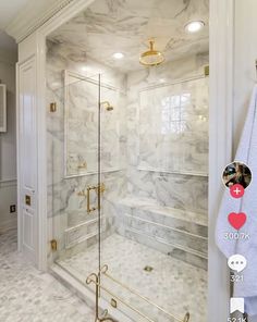 a bathroom with white marble walls and floors