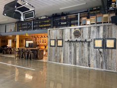 the inside of a building with tables, chairs and basketball hoop hanging from the ceiling