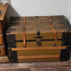 an old trunk is sitting on the floor