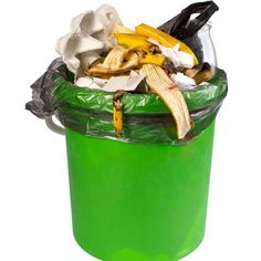 a green trash can filled with bananas and other garbage items on a white background,