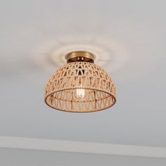 the light fixture is made out of wood and has a wicker pattern on it