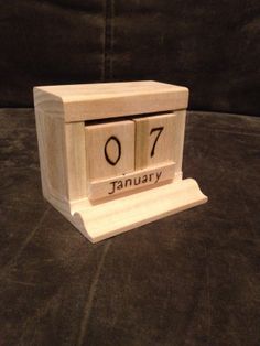 a wooden block with the word january written on it