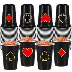 black and white striped cups with playing card symbols on them, each cup has four different colors