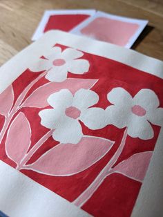 some red and white paper with flowers on it