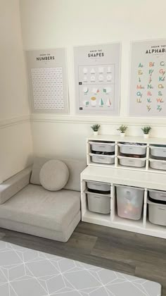 a room with several storage bins on the wall, and a couch in front of it