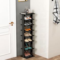 a black shoe rack with several pairs of shoes on it in front of a door