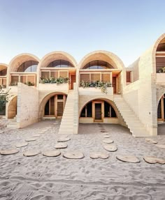 the building is made out of sand and has many circular stairs leading up to it