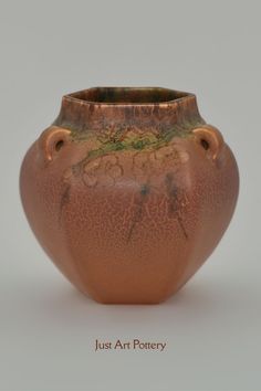 a brown vase sitting on top of a table