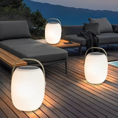 outdoor furniture with lights around them on a deck