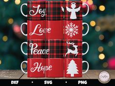 four red plaid coffee mugs with white lettering on them and christmas decorations in the background