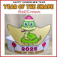 a happy chinese new year card with a cartoon snake on top of a paper crown