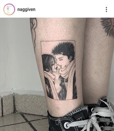 a couple kissing each other on their legs with the same tattoo as they stand next to each other