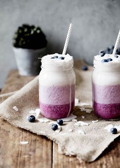 two mason jars with blueberries and whipped cream