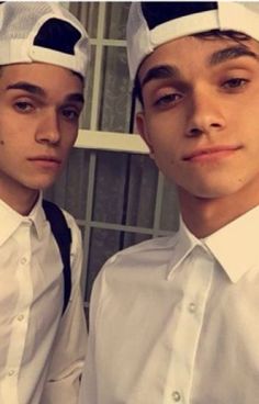 two young men wearing white hats and ties