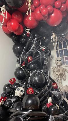 a bunch of balloons that are in the shape of a tree with skeletons and skulls on them