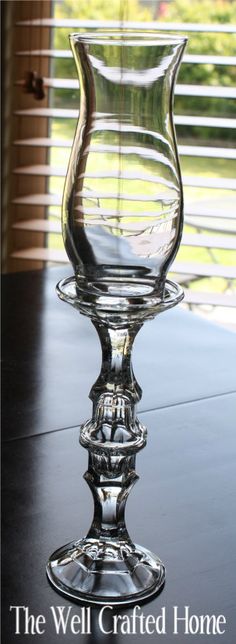 a glass vase sitting on top of a table