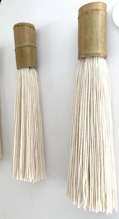 two white tassels hanging on the wall