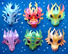 six masks with different colors and shapes on a blue background, one is made to look like a dragon's head