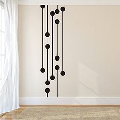 a room with white walls and black circles on the wall, along with a rug