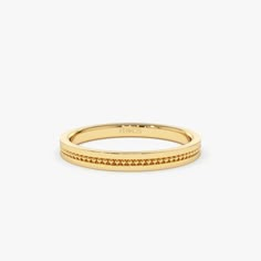 a yellow gold band with small diamonds on it