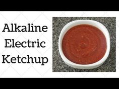 a white bowl filled with red sauce on top of a counter next to the words alkalne electric ketchup