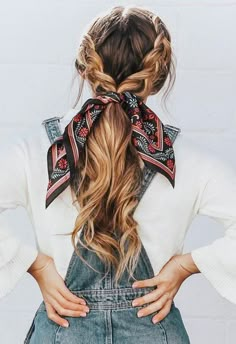 a woman with her back to the camera, wearing overalls and a bandana