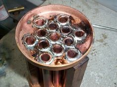 an old metal container filled with lots of silver and brown stuff sitting on top of a table