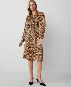 Unleash your wild side with the Ann Taylor Animal Print Tie Neck Midi Dress. This captivating piece is perfect for transitioning from day to night with its elegant animal print and flattering tie neck design. 

- Size: Regular - 2
- Color: Tan
- Material: 100% Polyester
- Gender: Female
- Fit: Hits below the knee
- Features: V-neck with ties, long sleeves with shirred sleeve caps and button cuffs, button front placket, front and back yoke with shirring below, hidden side zipper, lined body

Mach Fall Tie-neck Dress For Work, Fall Leopard Print Knee-length Midi Dress, Taylor Animal, Shirred Sleeve, Weekend Sweater, Weekend Dresses, Tan Woman, Long Sleeve Dresses, Sleeve Dresses