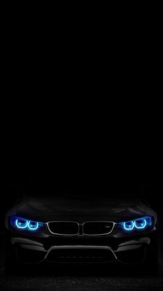 the front end of a black car with blue lights