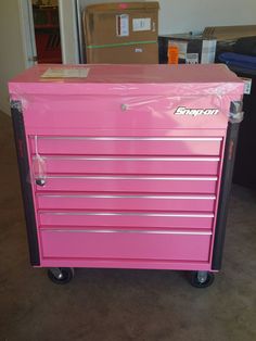 a pink tool box sitting on top of a dolly