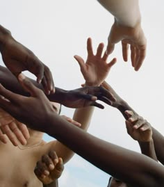 a group of people reaching their hands together