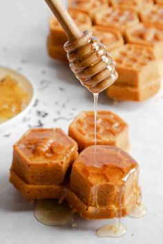 honey being drizzled onto some waffles