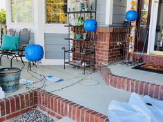 the front porch is decorated with blue lanterns