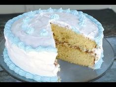 a cake with white frosting and blue icing is cut in half to show the inside