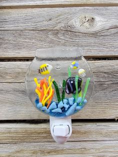 a glass fish bowl with sea life in it