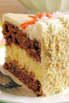 a slice of carrot cake on a plate with a fork