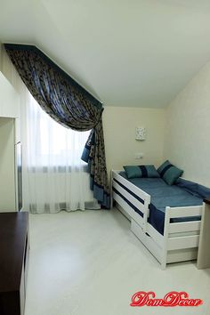 a room with a bed and curtains in it