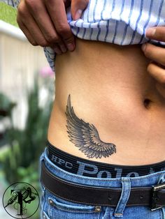 a woman's stomach with an eagle tattoo on her lower body and the words do it