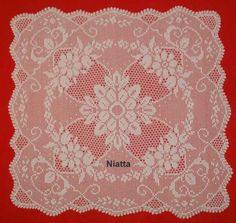 a white doily on a red background with the word natta written in it