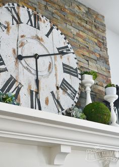 a large clock sitting on top of a mantle