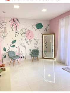 a room with flowers painted on the wall and two chairs in front of a mirror