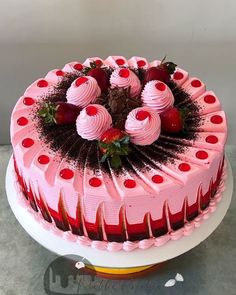 a strawberry cake with chocolate decorations on top