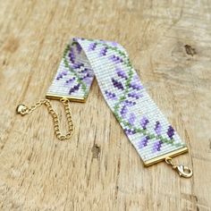 a close up of a lanyard on a wooden surface with a chain attached to it