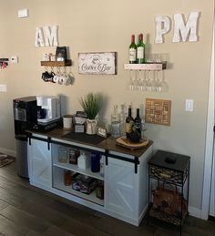 there is a small bar in the kitchen with wine glasses and bottles on the counter