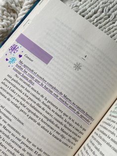 an open book sitting on top of a blanket