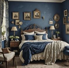 a bedroom with blue walls and pictures on the wall