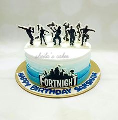 a birthday cake with figurines of people on it